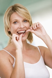 Woman Flossing Teeth